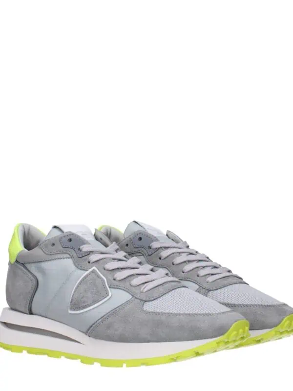 Bright gray sneakers with neon yellow accents, sporty design, cushioned soles, and breathable mesh upper, perfect for casual wear and athletic activities.