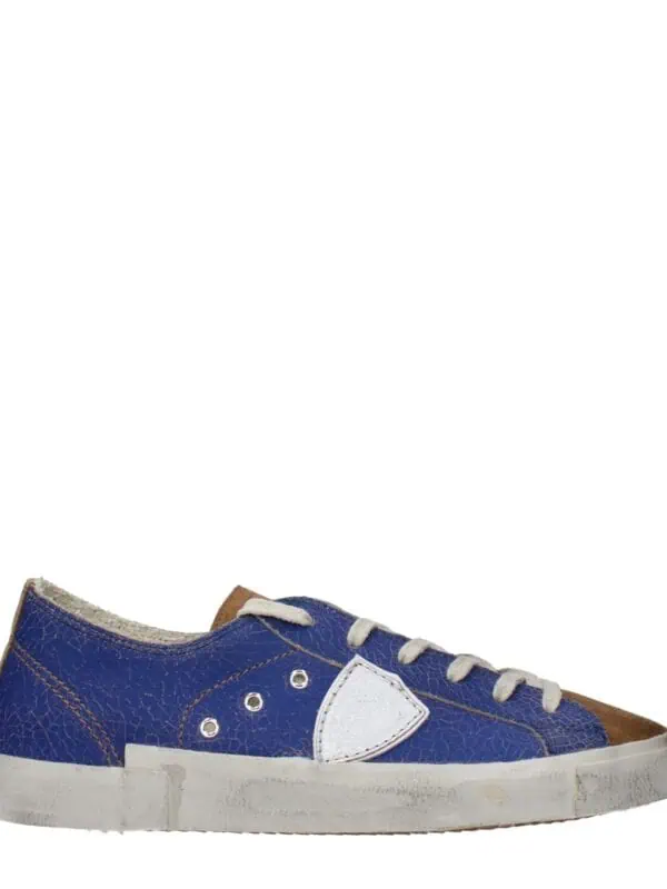 1. Vintage distressed blue and white sneaker with brown accents, casual style, and worn-out look for streetwear fashion.