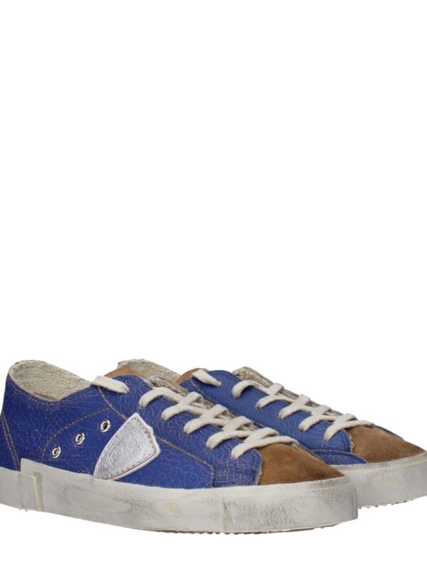 Vintage distressed blue and brown leather sneakers with white laces and sole, retro style, perfect for casual wear and adding a stylish touch to everyday outfits.