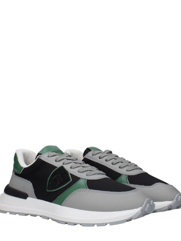 Designer athletic sneakers with a modern blend of grey, black, and green accents for stylish comfort and versatile daily wear.