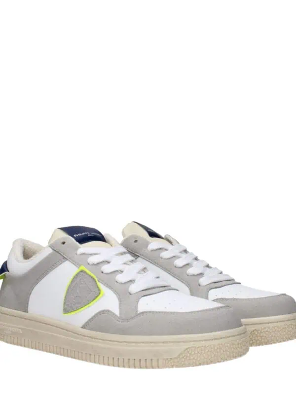 1. White and gray designer sneakers with neon yellow accents and textured sole for stylish casual wear.