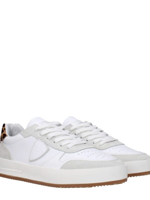 Leather and suede platform sneakers with leopard print accent on the heel, crafted for a stylish and comfortable look. Perfect for casual or trendy outfits.