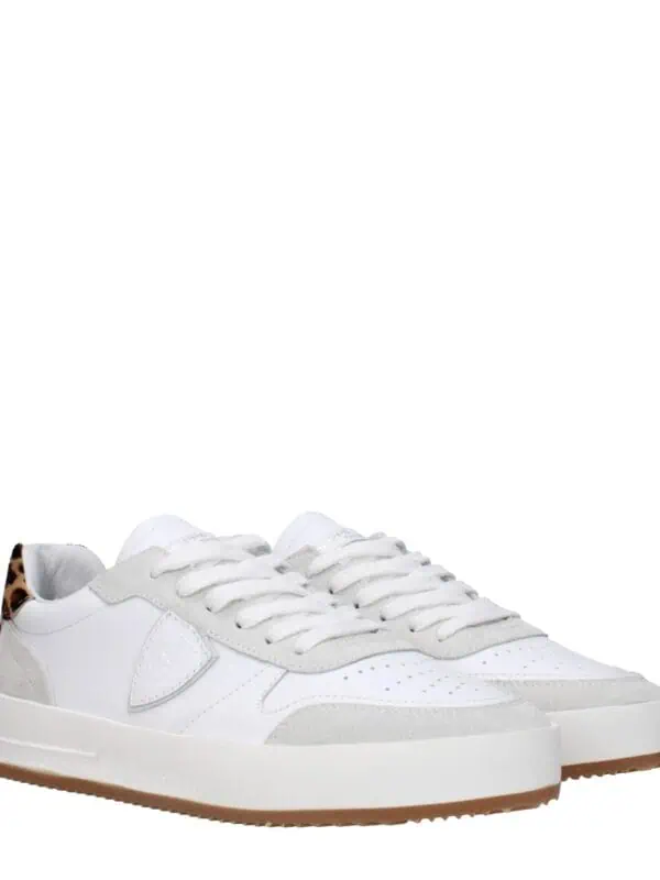 Leather and suede platform sneakers with leopard print accent on the heel, crafted for a stylish and comfortable look. Perfect for casual or trendy outfits.