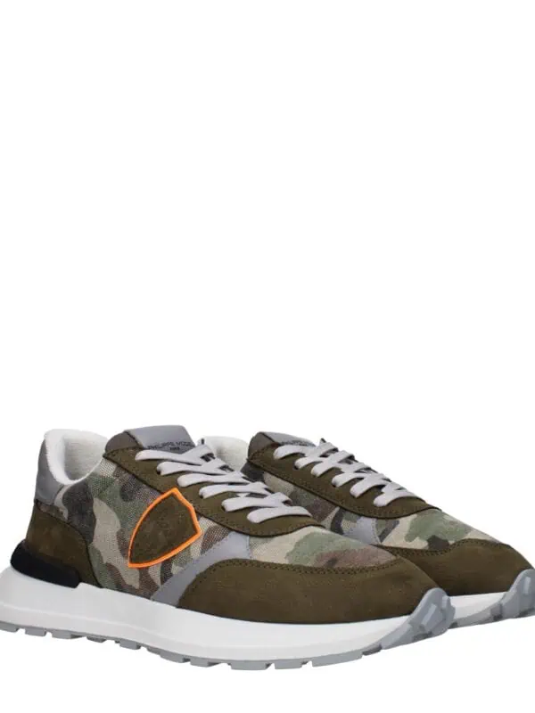 Men's camouflage sneakers with white laces, orange accent, and cushioned sole, perfect for casual wear and fashion-forward street style.