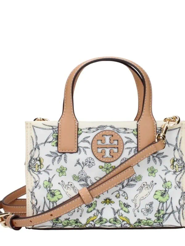 Elegant designer handbag with floral print, tan leather accents, top handles, and an adjustable shoulder strap. Perfect for fashionable outings and versatile styling.