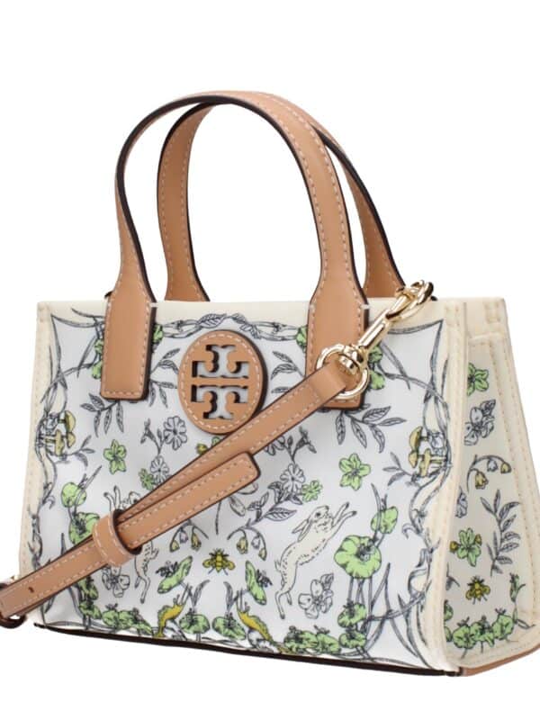 Elegant designer handbag with intricate floral and animal print, featuring tan leather handles and gold hardware, perfect for stylish accessorizing.