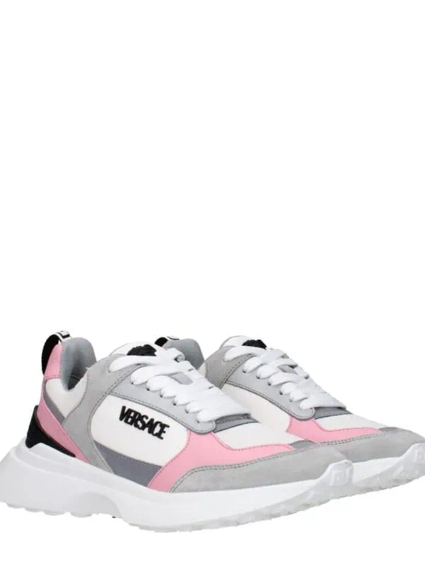 Versace trendy women's sneakers with white, pink, gray, and black accents, featuring a chunky sole and logo, perfect for fashionable casual wear and making a style statement.