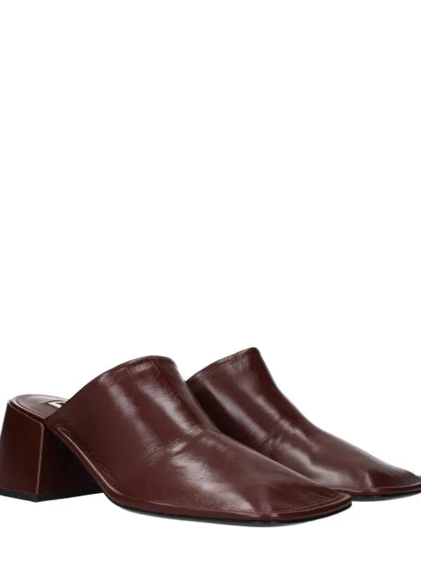 Slip-on leather mules with a sleek pointed toe and block heel in rich burgundy for stylish comfort and versatile wear.