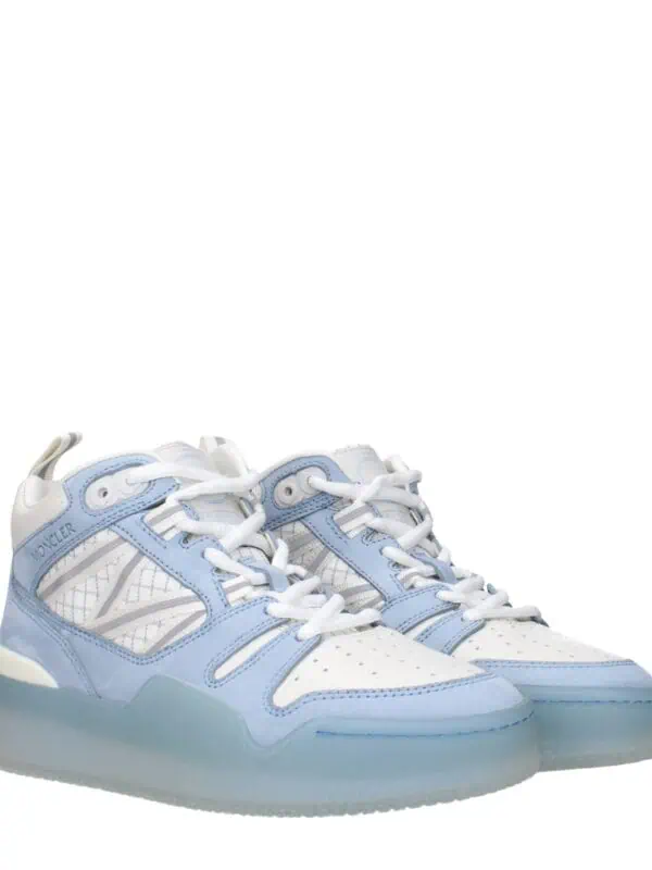 Light blue and white Moncler sneakers with a sleek design, padded ankle support, and durable sole, perfect for casual wear and athleisure styles.
