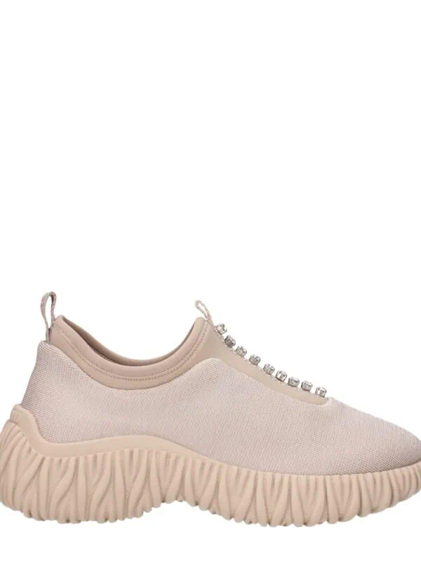 Beige athletic sneaker with sculpted sole, fabric upper, and decorative rhinestone details, combining comfort and style for casual or sporty wear.