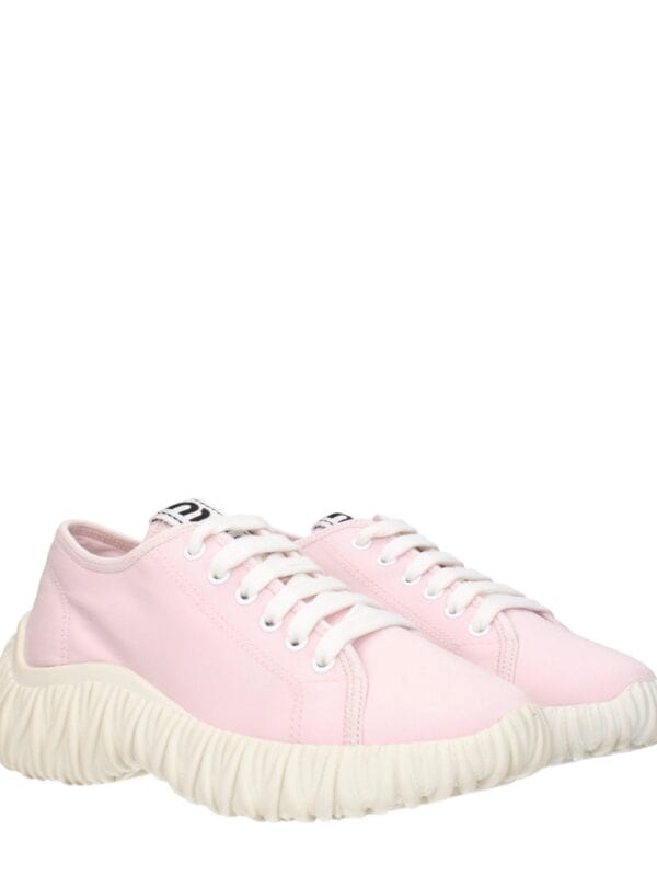 Pink casual sneakers with chunky textured soles and white laces, perfect for everyday wear and trendy fashion statements.