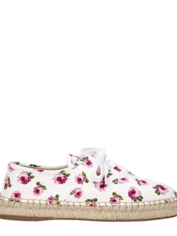 Pink floral-print espadrille sneaker with white laces and natural jute sole, perfect for casual summer outfits and outdoor activities, combines comfort and style.