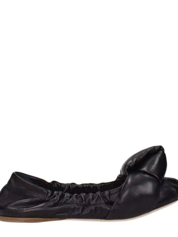 Soft black leather ballet flats with a ruched ankle detail and a rounded toe, perfect for casual and elegant occasions. Made from high-quality materials for comfort and style.