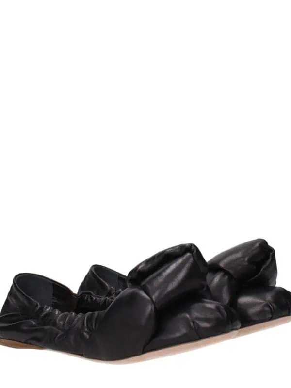 Soft black leather ballet flats with ruched detailing and a cushioned sole for comfortable everyday wear. Designed for stylish, casual elegance with a focus on comfort and versatility.