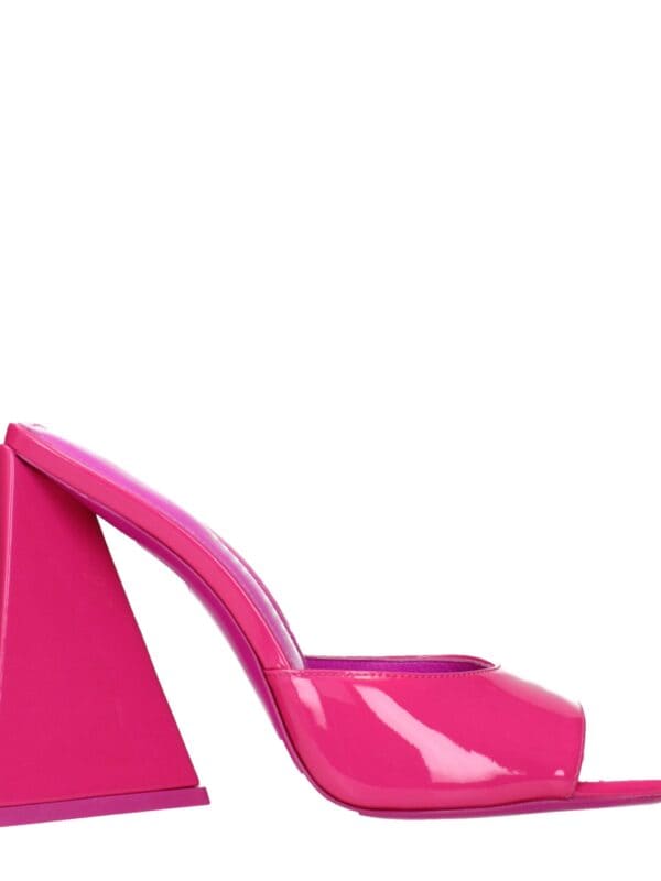 Bright pink patent leather high heel mules with a unique geometric block heel design, perfect for a bold fashion statement.