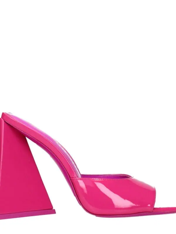 Bright pink patent leather high heel mules with a unique geometric block heel design, perfect for a bold fashion statement.