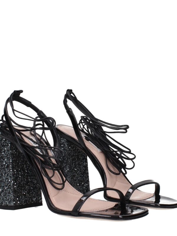 Stunning black high-heeled sandals with intricate strap design and glittery block heel, perfect for glamorous nights out and special occasions.
