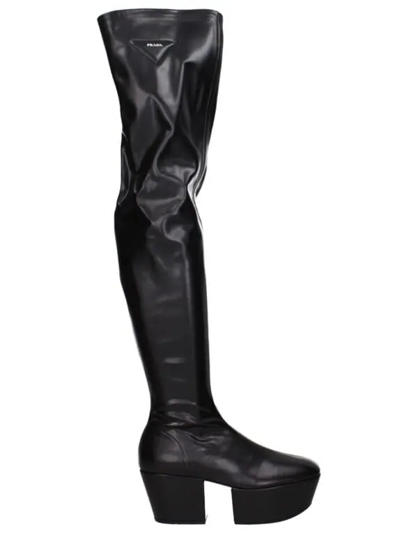 Prada over-the-knee black leather high-heeled platform boots with sleek design and stylish fold-over detail. Perfect for fashionable, bold winter or night-out attire.