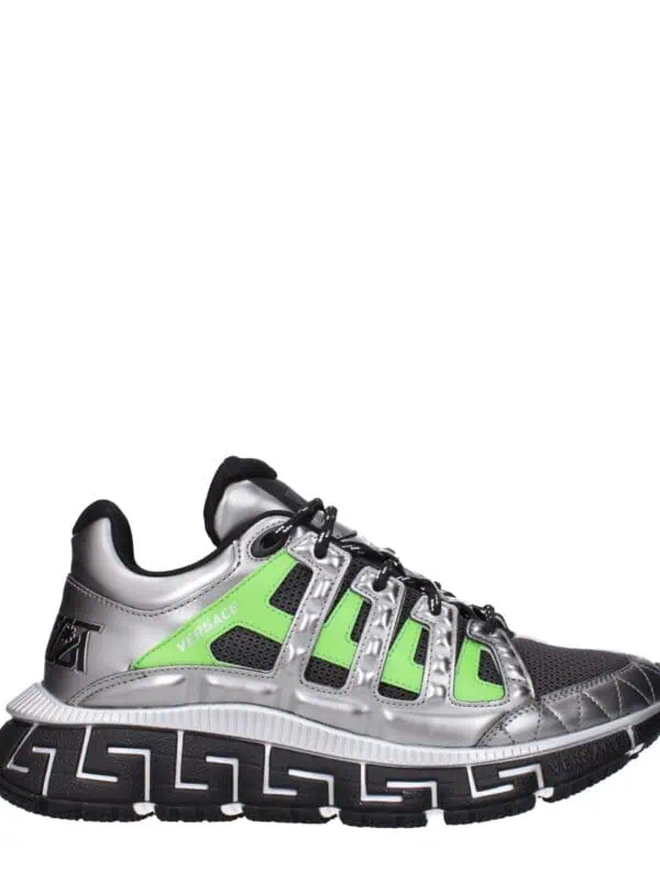 Bold silver and black Versace sneakers with neon green accents, featuring the iconic Greek key pattern on the sole and luxury branding. Perfect for stylish, high-end athletic wear.