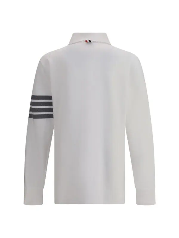 Luxury white polo shirt with grey striped sleeve design, perfect for stylish casual wear.