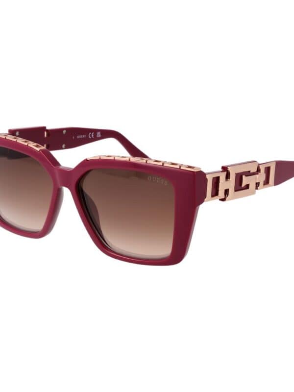 Pink square designer sunglasses with gradient lenses and gold accents, featuring the GUESS logo on the temples. Perfect for stylish sun protection and trendy fashion statements.