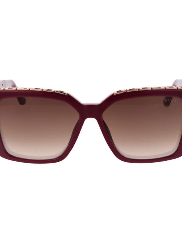 Oversized square sunglasses with gradient brown lenses and a bold maroon frame, featuring gold accents on the temples for a luxurious look.