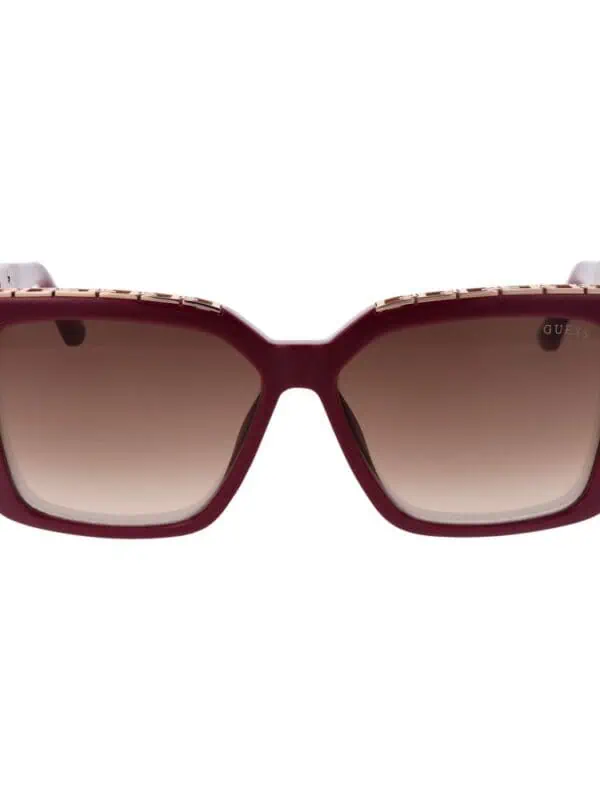 Oversized square sunglasses with gradient brown lenses and a bold maroon frame, featuring gold accents on the temples for a luxurious look.
