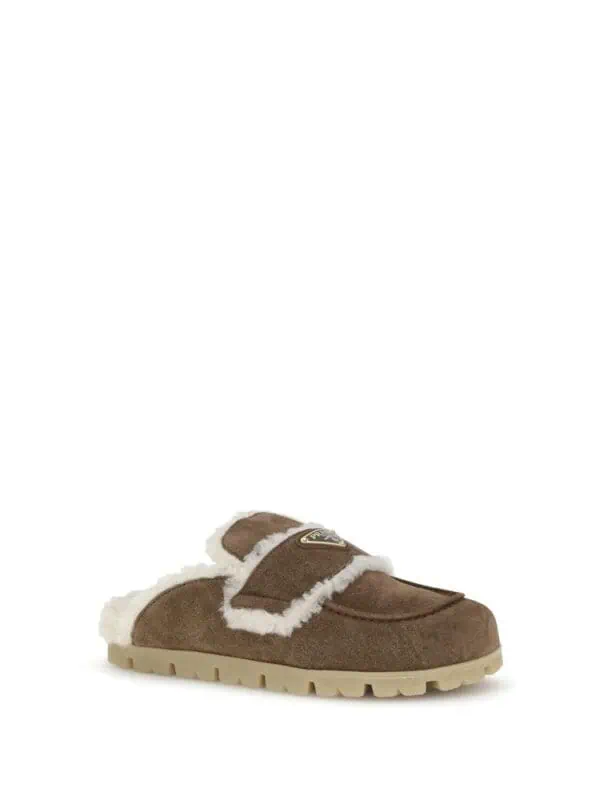 Cozy brown shearling slipper with fur lining and rugged outsole, perfect for indoor comfort and winter warmth. Stylish yet functional footwear from Lux Brands.