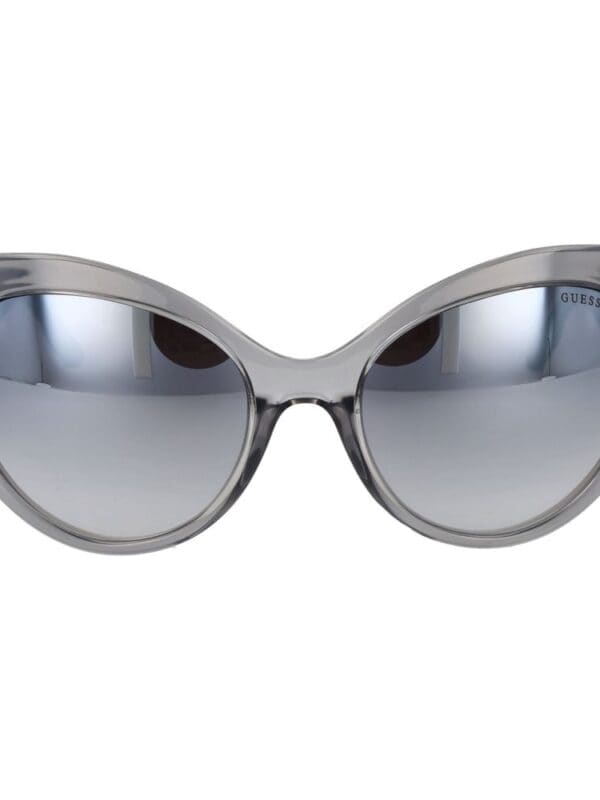 Round gray sunglasses with tinted lenses and a stylish modern design. Perfect for sunny days or fashion-forward occasions. Crafted by Guess for a chic and sophisticated look.