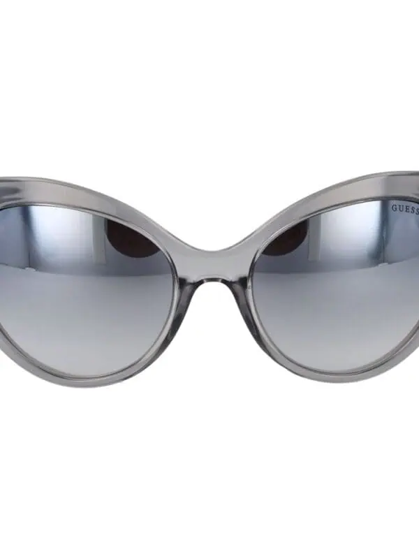 Round gray sunglasses with tinted lenses and a stylish modern design. Perfect for sunny days or fashion-forward occasions. Crafted by Guess for a chic and sophisticated look.