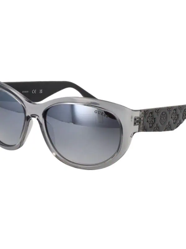GUESS sunglasses with a stylish transparent frame and dark tinted lenses, perfect for a trendy summer look.