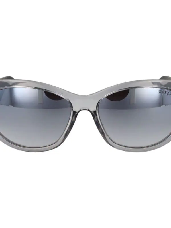 Sunglasses with a sleek, modern design featuring gradient lenses and a transparent gray frame by Guess. Perfect for fashion-conscious individuals seeking stylish sun protection.