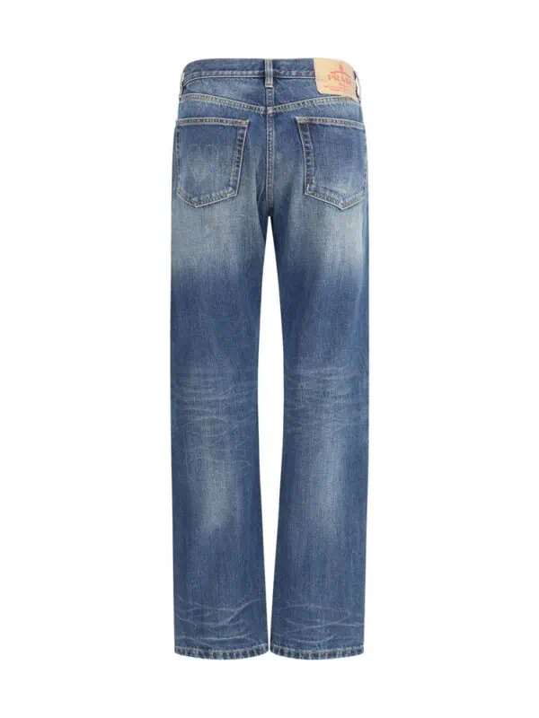 Distressed blue denim jeans with a relaxed fit, high waist, and vintage wash, perfect for casual and streetwear styles.