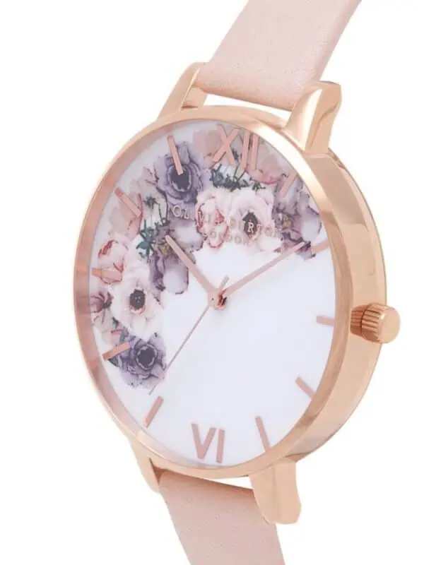 Elegant rose gold watch with a floral dial design and a soft pink strap, perfect for stylish women.