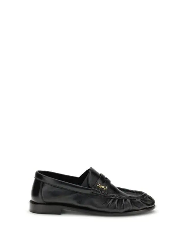 Lux Brands black leather loafers with gold logo detail, stylish and comfortable men's footwear for versatile fashion statements.