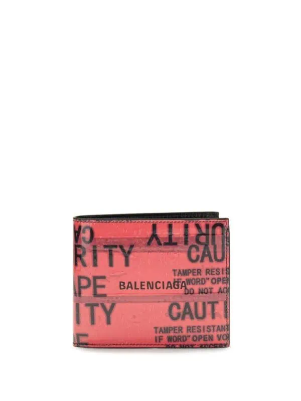 Black and red Balenciaga cardholder wallet with "CAUTION" and "TAMPER RESISTANT" text, designed for luxury fashion accessory collection.