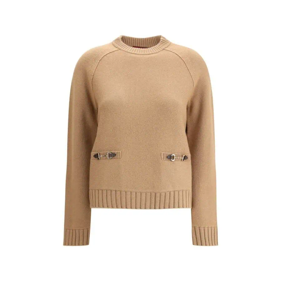 Soft beige sweater with metal buckle details and ribbed cuffs and hem, perfect for stylish winter wear.