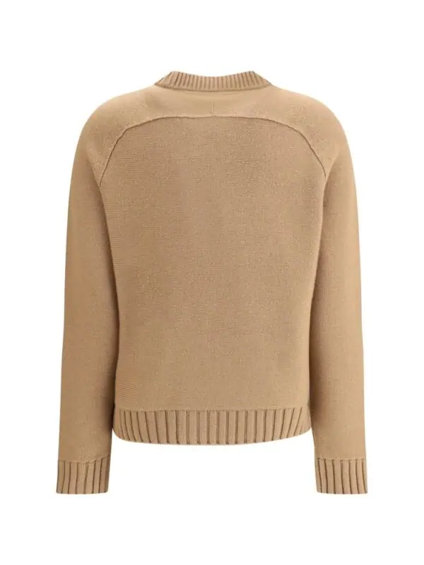 Soft beige knit sweater with ribbed cuffs and neckline, perfect for a casual chic look. Crafted for comfort and style, ideal for fall and winter wear.
