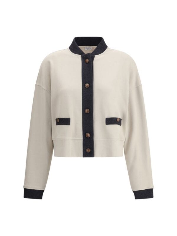 Cream and black varsity style women's jacket with large front buttons and patch pockets, perfect for casual and chic fashion statements.
