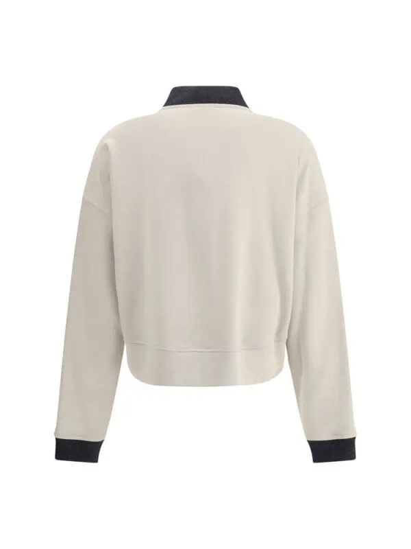 White oversized sweatshirt with black collar and cuffs, stylish casual wear for men and women from Lux Brands. Perfect for cool weather, blending comfort and fashion.