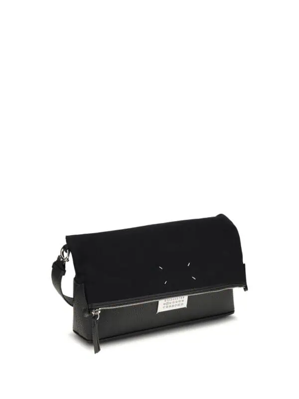 Black designer clutch bag with zip closure and adjustable strap for versatile styling.
