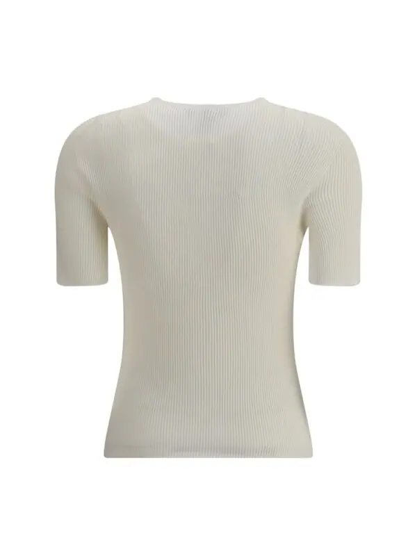 Soft cream ribbed short-sleeve knit top from Lux Brands for a chic, minimalist look. Perfect for casual or elegant outfits with its versatile, timeless design.