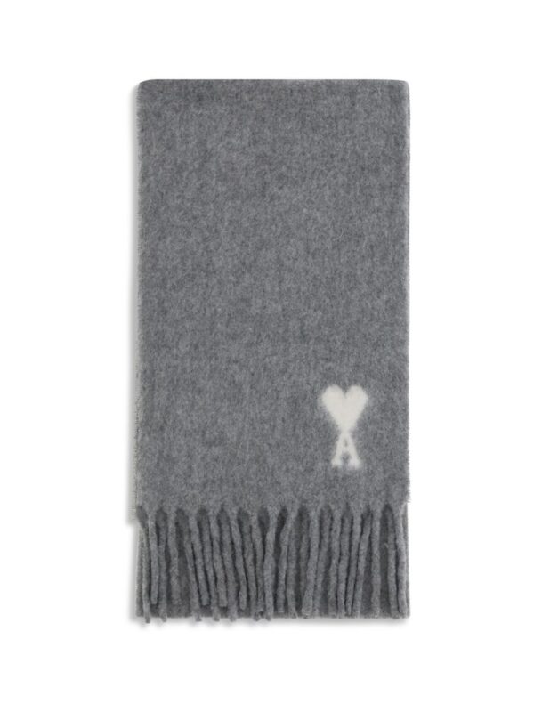 Soft grey scarf with a white heart and "A" monogram, featuring fringed ends, ideal for stylish winter fashion.