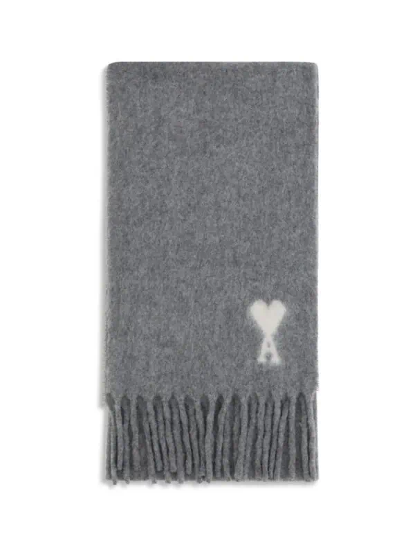 Soft grey scarf with a white heart and "A" monogram, featuring fringed ends, ideal for stylish winter fashion.