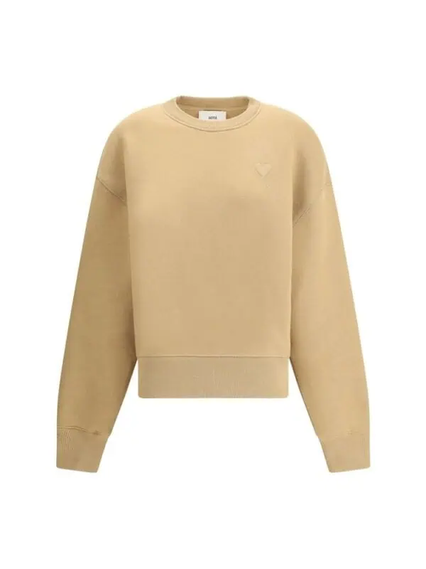 Cream beige oversized sweatshirt with subtle embroidered logo on chest.