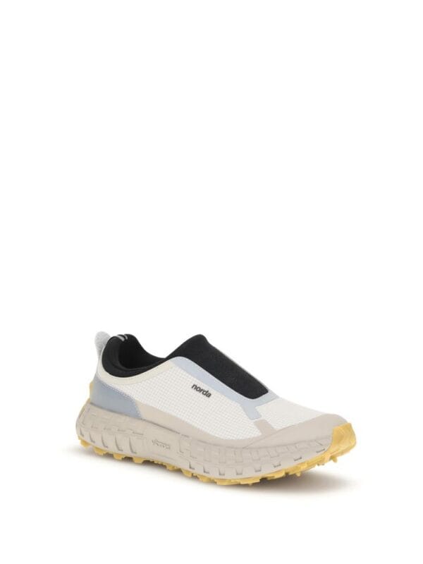 Comfy white and black Nordic-inspired running shoes with a chunky rubber sole, designed for style and comfort during outdoor workouts and casual outings.