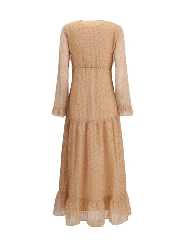 Flowy peach-tiered maxi dress with long puff sleeves, delicate dotted pattern, and ruffled hem, perfect for elegant spring or summer occasions.