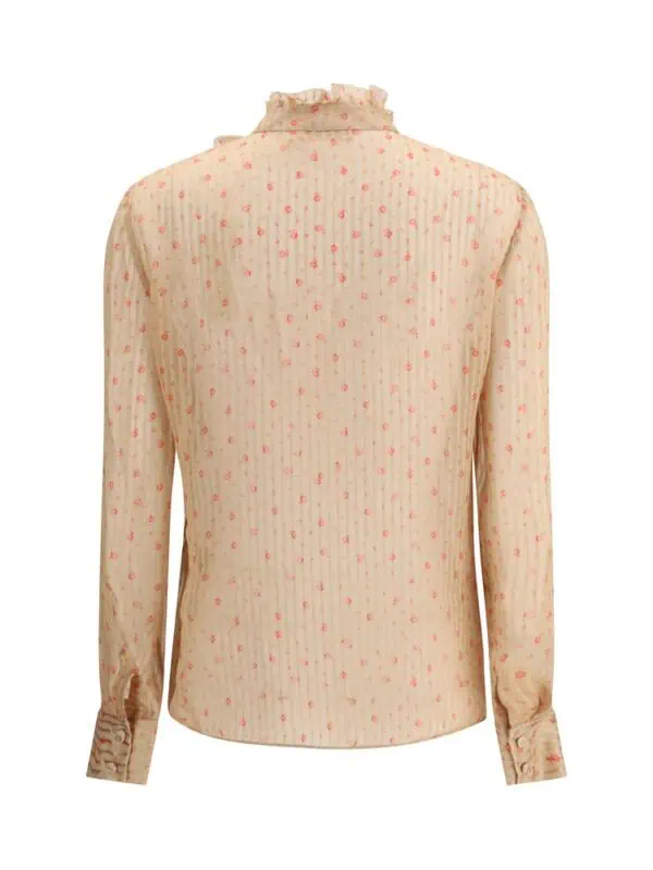 Cream-colored floral printed satin blouse with ruffled collar and buttoned cuffs. Elegant and vintage-inspired top, perfect for a sophisticated wardrobe addition.