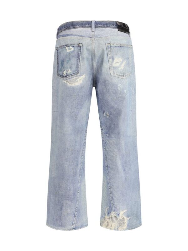 Ripped light blue distressed wide-leg jeans with vintage wash and fading details.