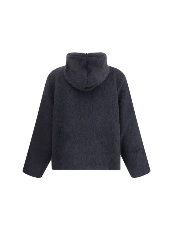 Soft black faux fur hooded jacket for stylish winter wear. Cozy and luxurious design perfect for cold weather, offering comfort and warmth with a contemporary look. Ideal for fashionable winter outfits.